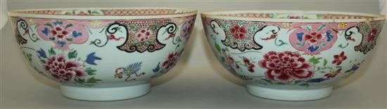 A pair of Chinese famille rose bowls, Qianlong period, 23.3cm, some faults, wood stands